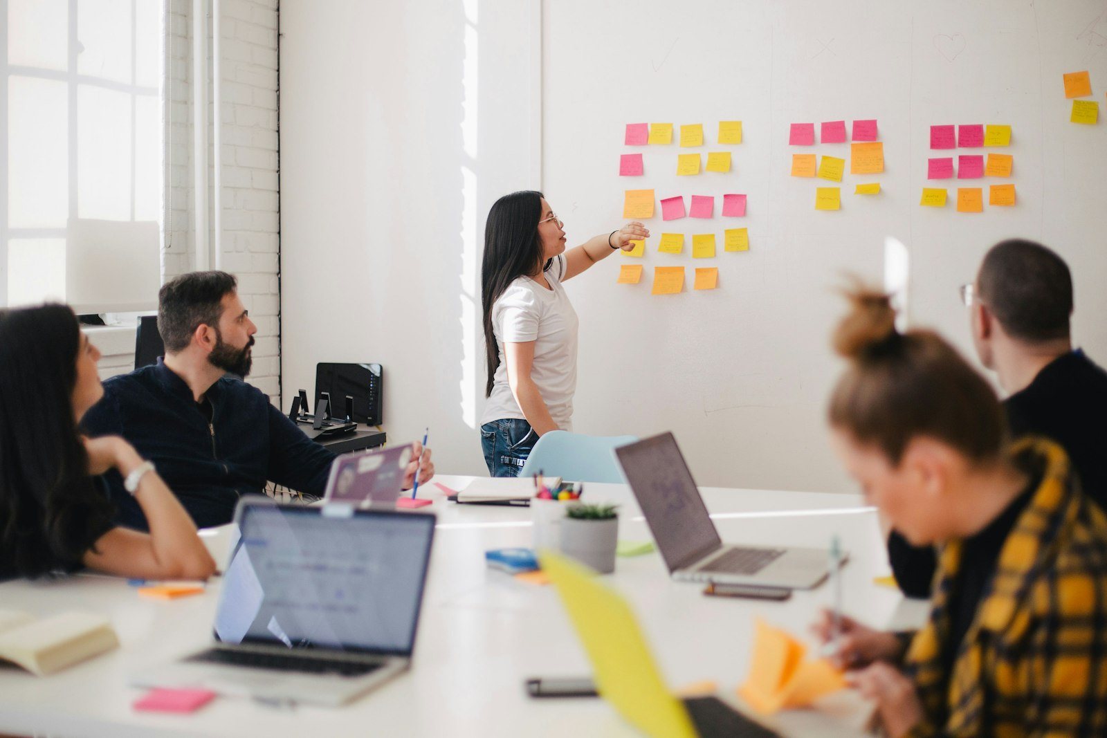 Small team reviewing work around a shared table